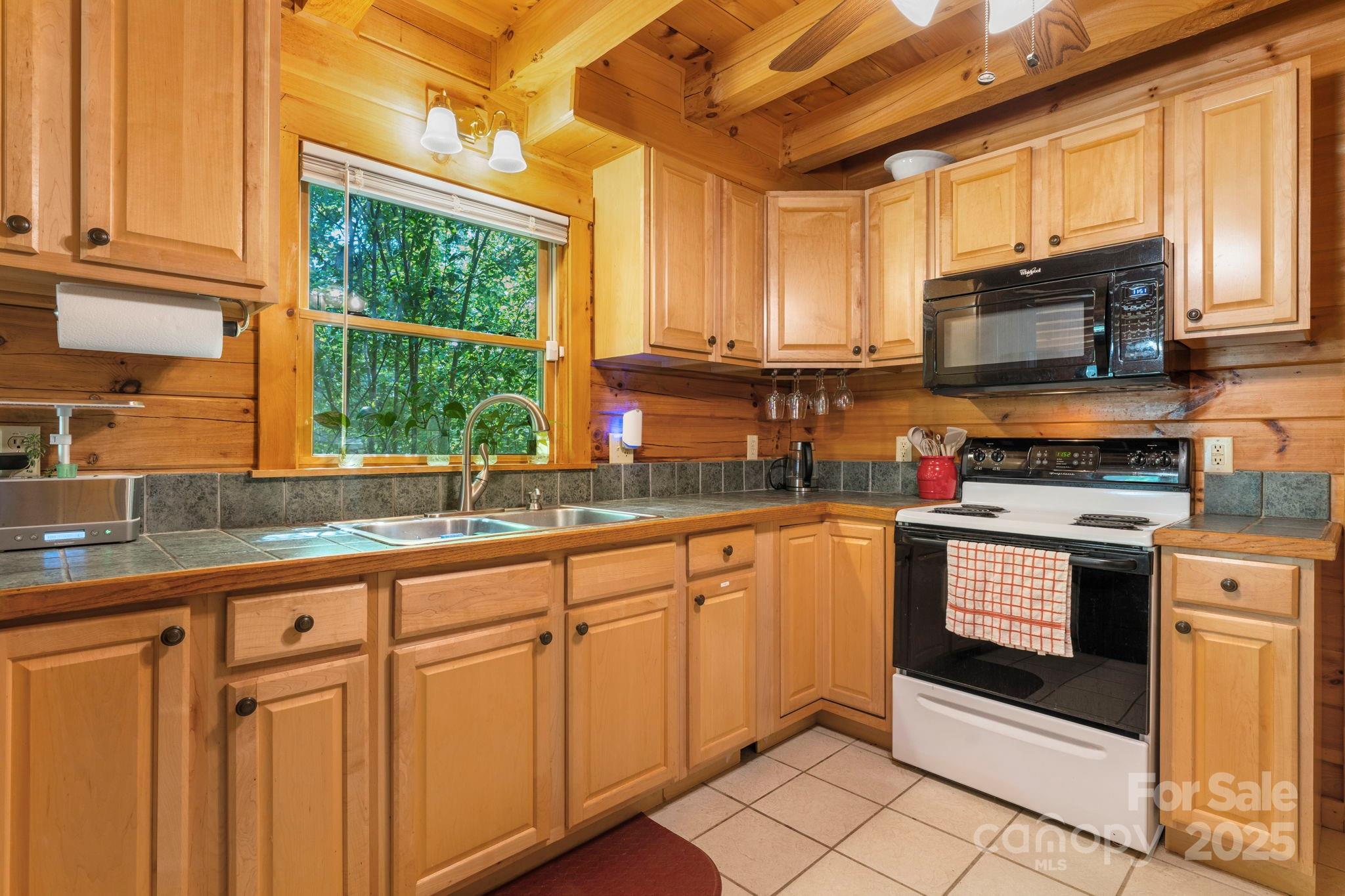 211 Granite Ridge Nebo, NC 28761 - Photo 10 of 43 a kitchen with stainless steel appliances granite countertop a stove sink and cabinets