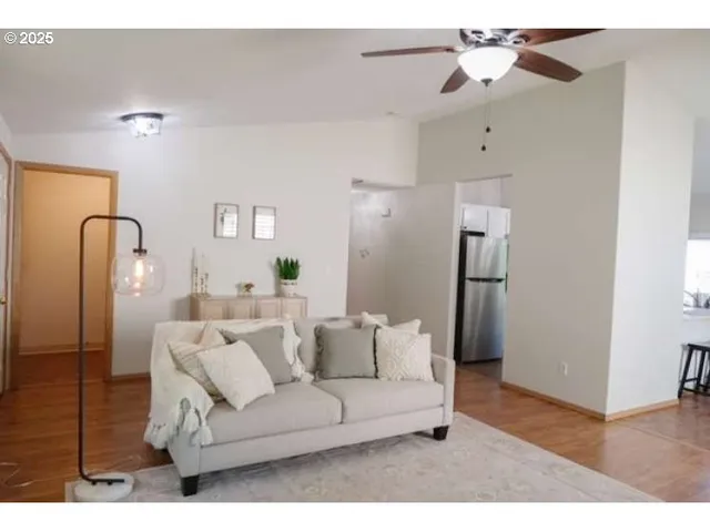 a living room with furniture and a wooden floor