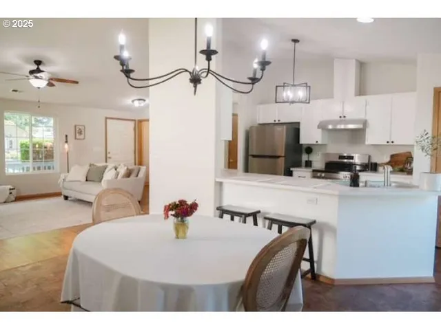 a kitchen with a table and chairs