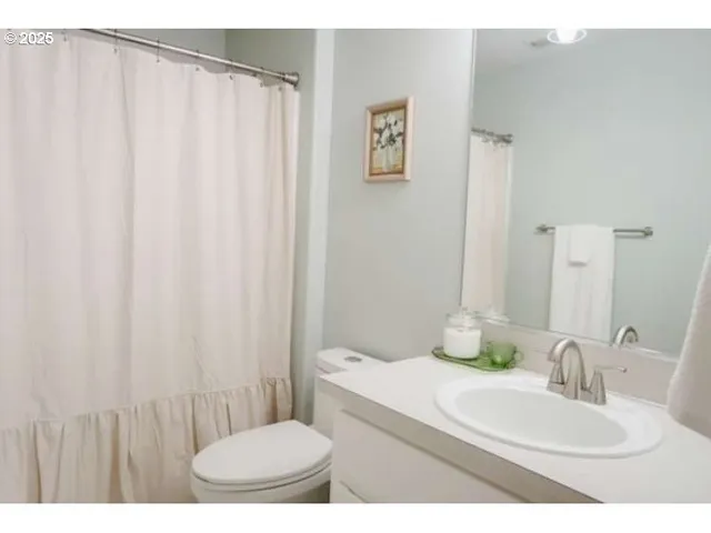 a bathroom with a toilet a sink and garden