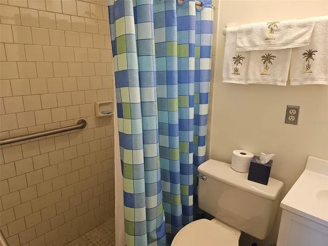 a white toilet sitting next to a bathroom sink
