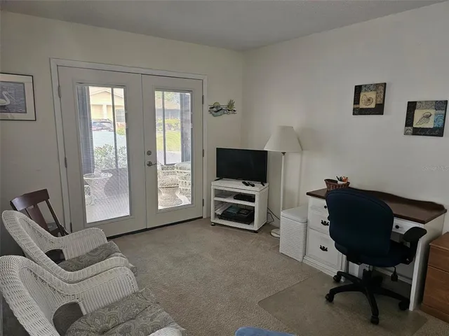 a livingroom with workspace and a couch
