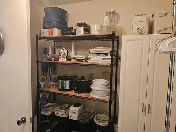 a kitchen with a stove and wooden floor