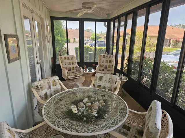 a living room with furniture and a floor to ceiling window