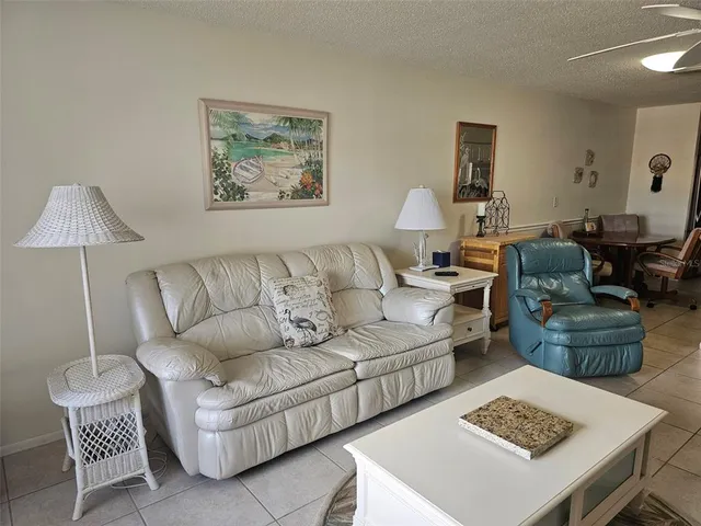 a living room with furniture and a lamp