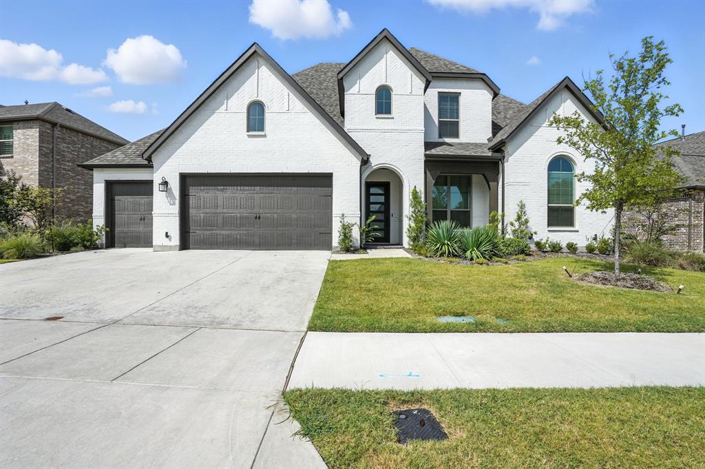 4621 Mount Vista Road Oak Point, TX 75068 - Photo 2 of 40 a front view of a house with a yard and garage