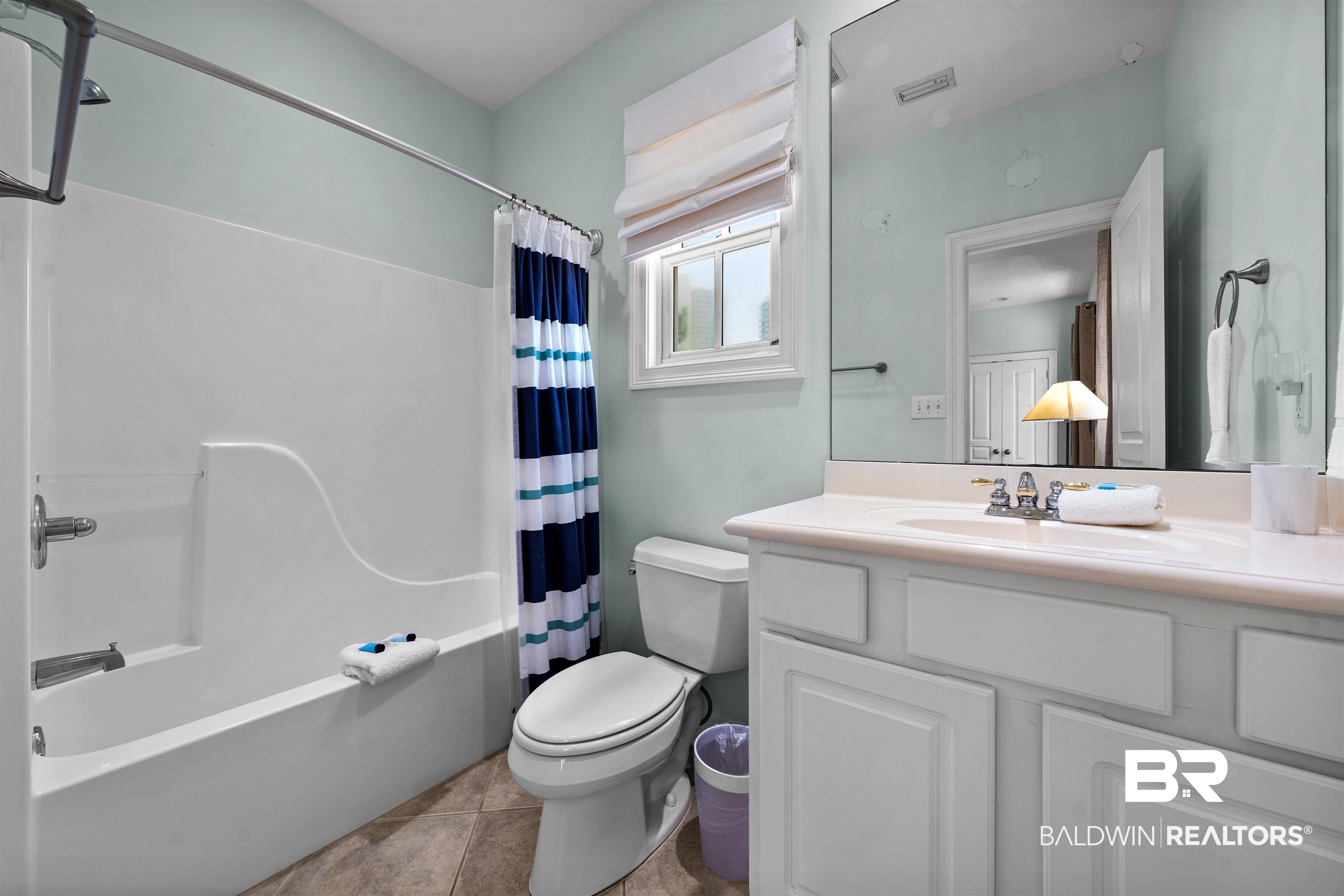 3434 Mariner Circle Orange Beach, AL 36561 - Photo 31 of 38 Full bathroom with shower / bath combo with shower curtain, toilet, vanity, and tile patterned floors