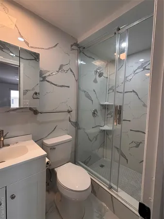 a bathroom with a toilet and a shower