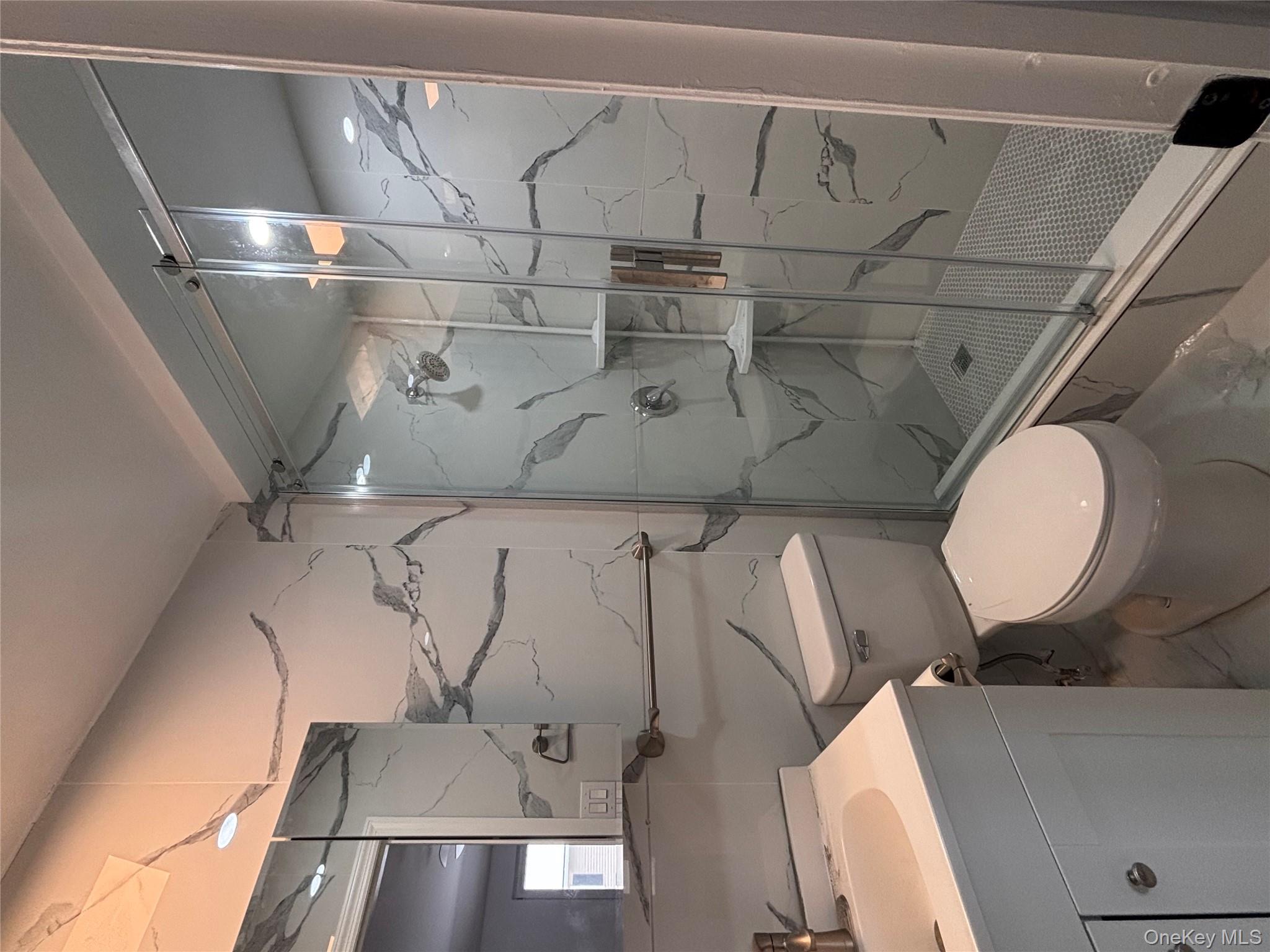 145-01 223rd Street, Unit 2 Queens, NY 11413 - Photo 11 of 12 a bathroom with a toilet and a shower