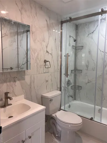 a bathroom with a sink toilet and shower