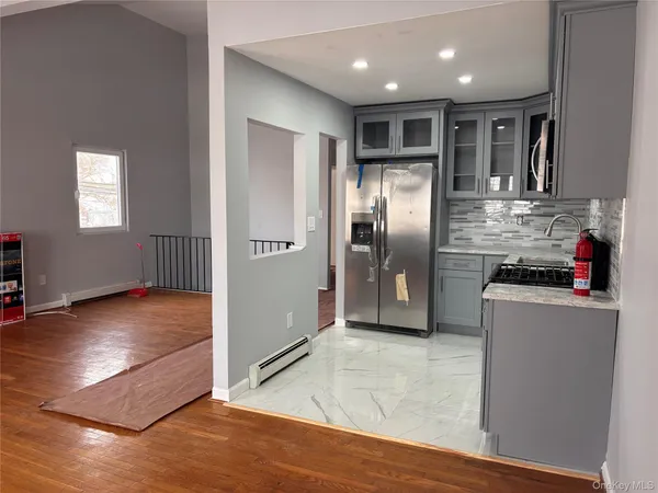 a kitchen with stainless steel appliances granite countertop a refrigerator and a sink