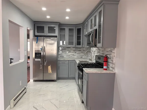 a kitchen with stainless steel appliances granite countertop a refrigerator and a sink