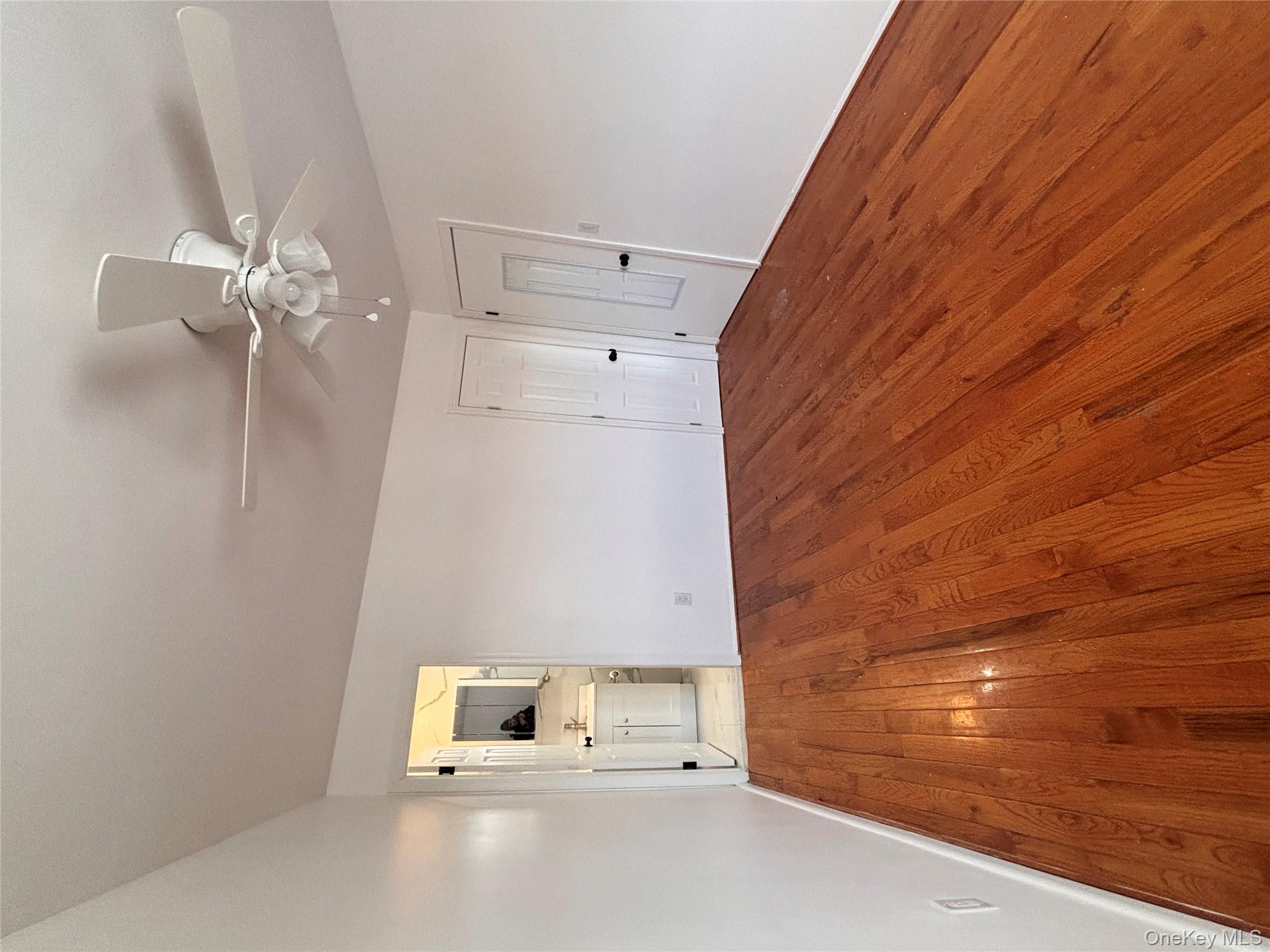 145-01 223rd Street, Unit 2 Queens, NY 11413 - Photo 10 of 12 a view of empty room with wooden floor