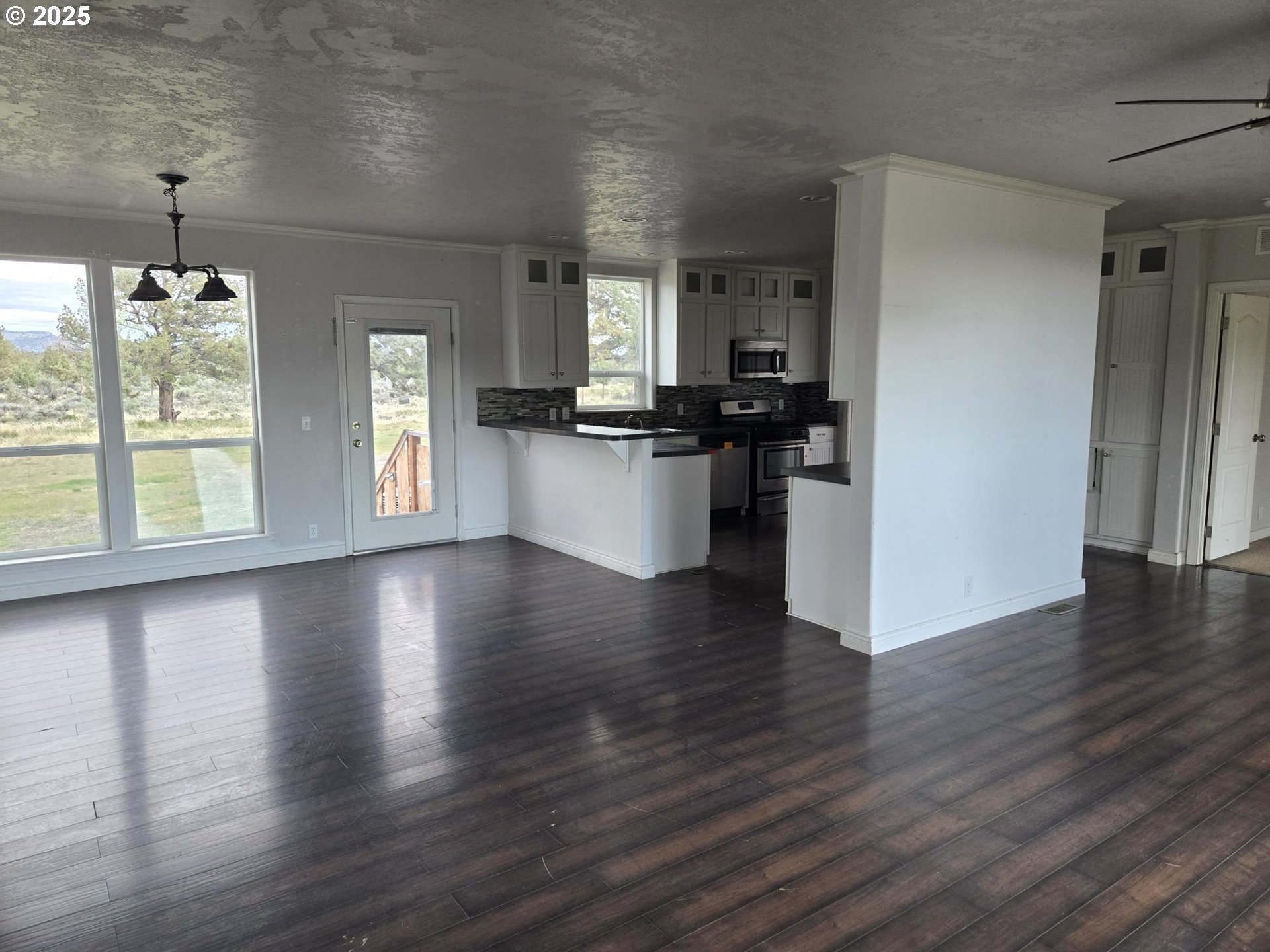 9290 Southwest 3115th Road Culver, OR 97734 - Photo 3 of 21 a view of a kitchen with furniture and wooden floor