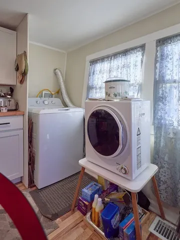 a living room with a couch and a washer dryer