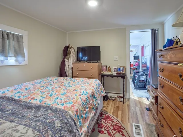 a bedroom with a bed and a television