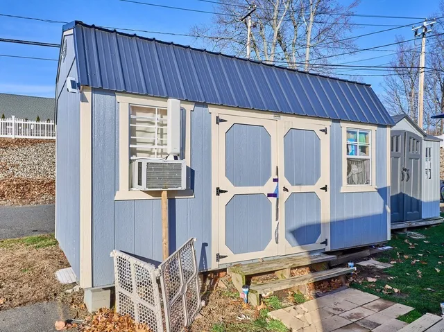 a view of a house with backyard and wooden fence