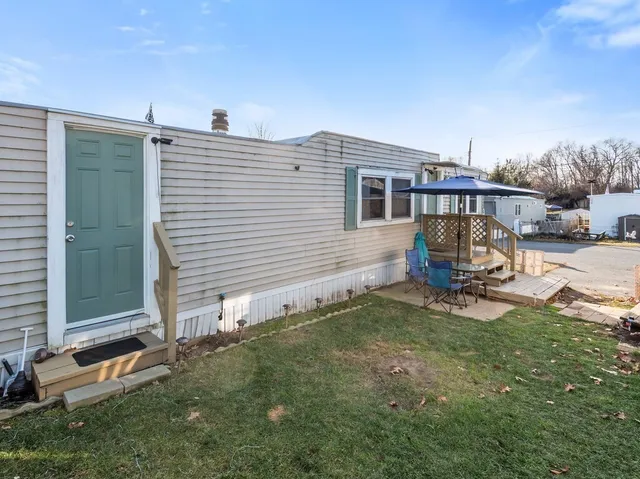 a view of a backyard with sitting area
