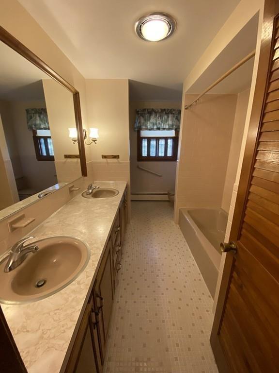 26 Charlton Road Dudley, MA 01571 - Photo 11 of 30 a bathroom with a sink a toilet and mirror