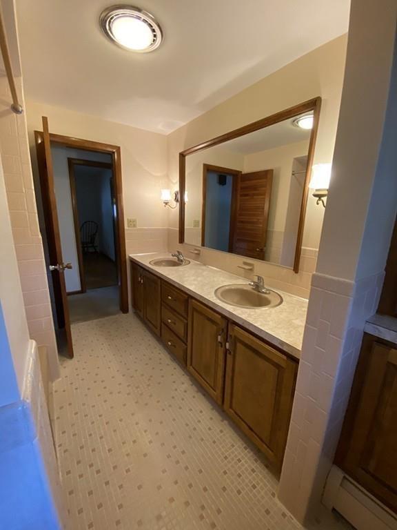 26 Charlton Road Dudley, MA 01571 - Photo 14 of 30 a bathroom with a double vanity sink and mirror