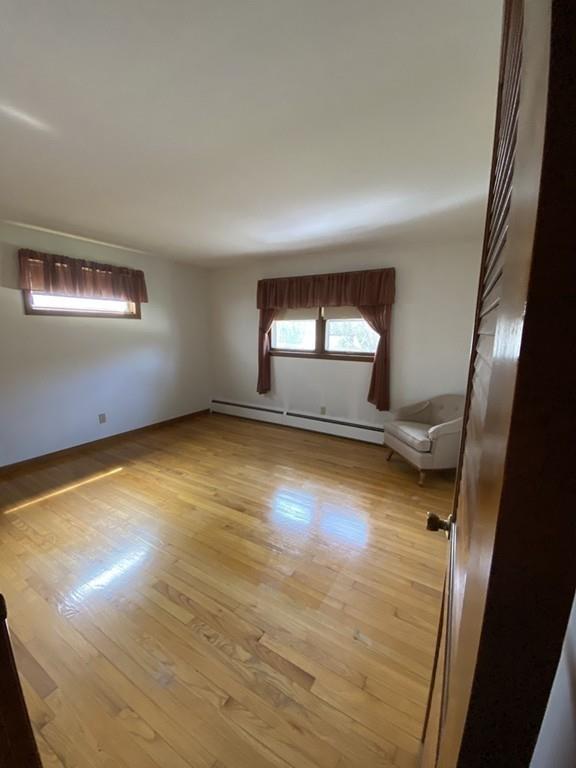 26 Charlton Road Dudley, MA 01571 - Photo 20 of 30 wooden floor in an empty room with a window