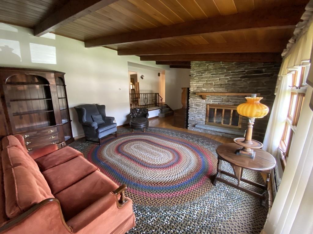 26 Charlton Road Dudley, MA 01571 - Photo 5 of 30 a living room with furniture a rug and a fireplace