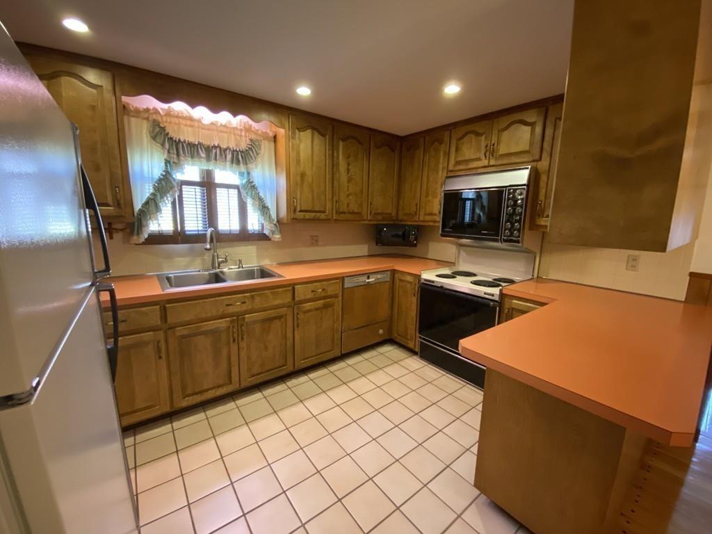 26 Charlton Road Dudley, MA 01571 - Photo 7 of 30 a kitchen with a sink a stove top oven and cabinetry
