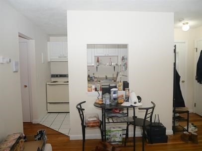 1027 Commonwealth Avenue, Unit 22 Boston, MA 02215 - Photo 2 of 4 a view of a dining room with furniture and wooden floor