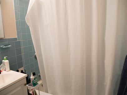 1027 Commonwealth Avenue, Unit 22 Boston, MA 02215 - Photo 4 of 4 a bathroom with a sink and curtain