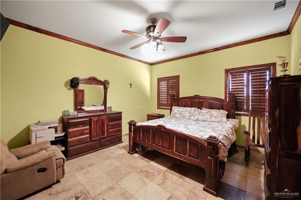14061 Benito A Ramirez Road Edcouch, TX 78538 - Photo 15 of 16 a bedroom with a bed and dresser