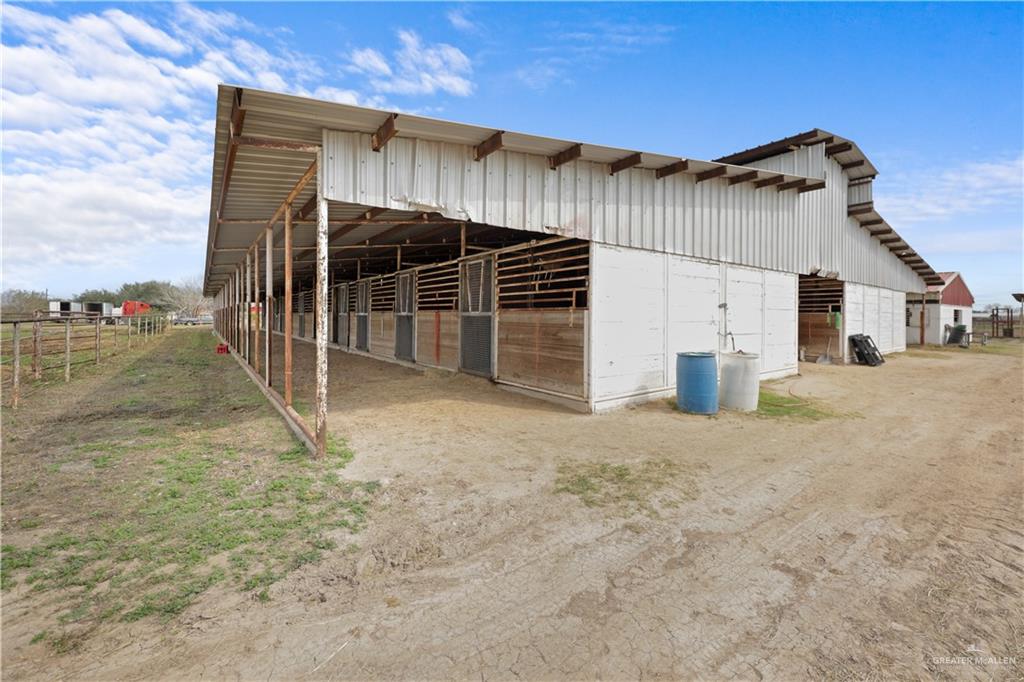 14061 Benito A Ramirez Road Edcouch, TX 78538 - Photo 4 of 16 a view of a house with a backyard and garage