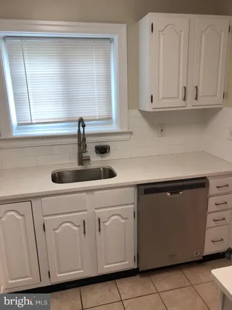 a kitchen with white cabinets