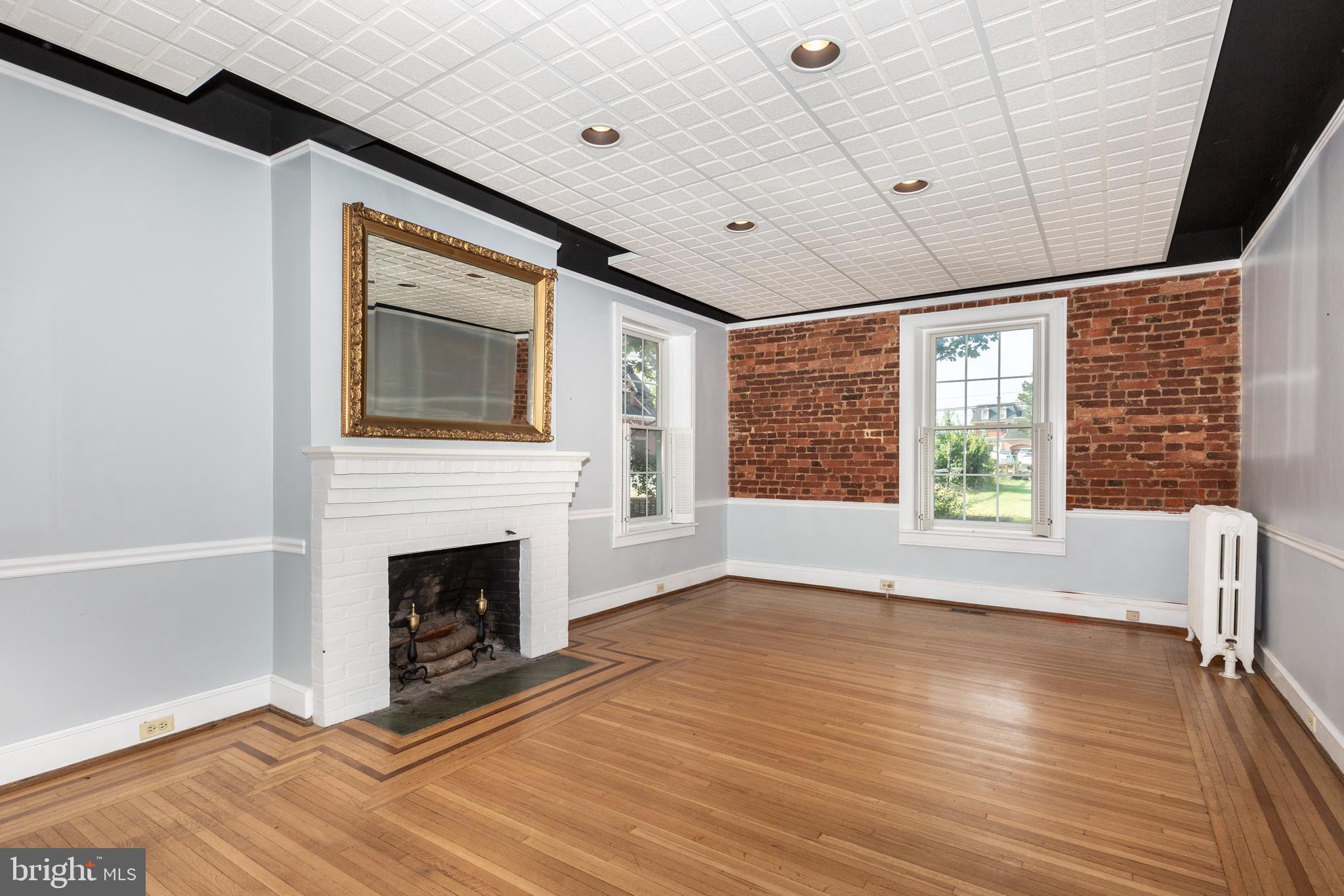 162 East Main Street Westminster, MD 21157 - Photo 11 of 50 Hardwood floors with wood burning fireplace