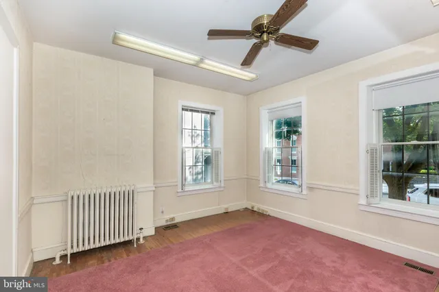 a view of an entryway with wooden floor and windows
