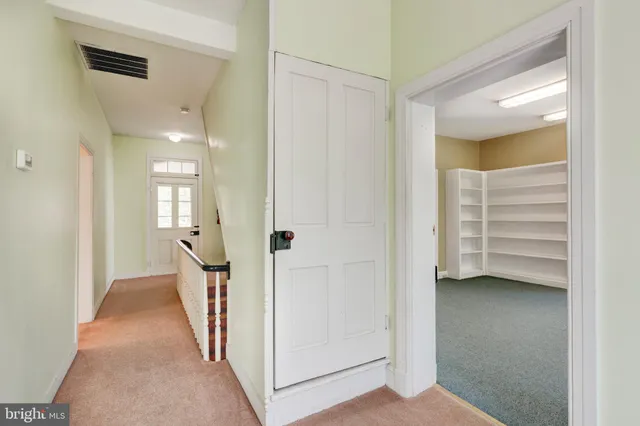 a bathroom with a granite countertop sink a toilet and a mirror
