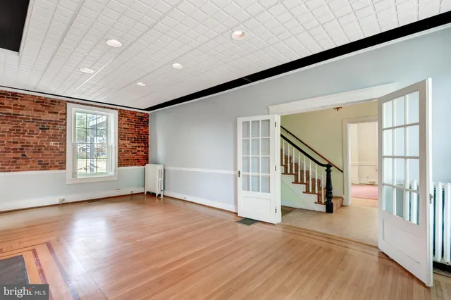 a living room with furniture a flat screen tv and a large window