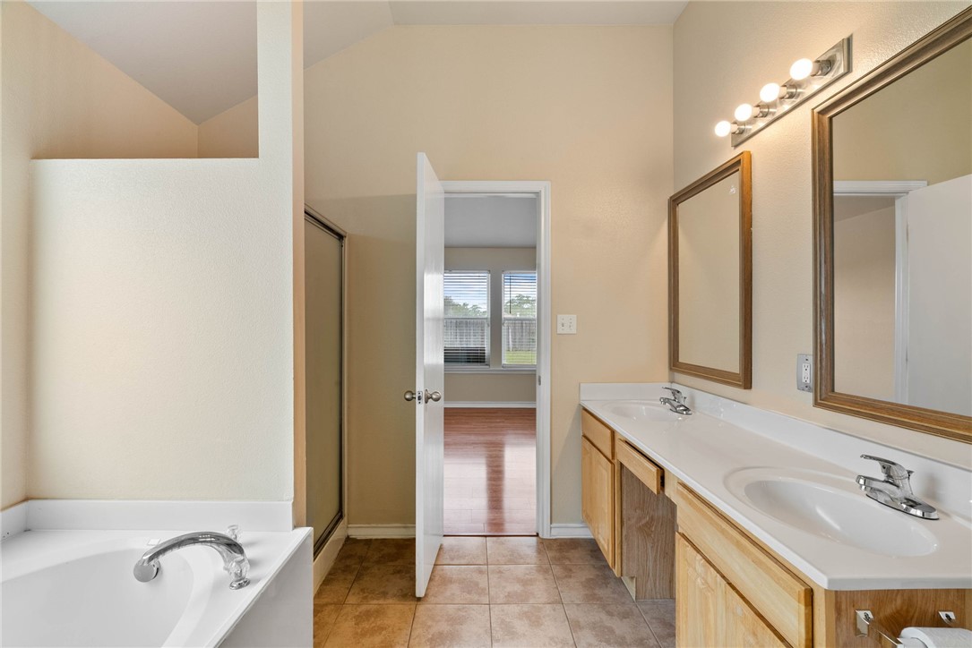 6606 Riding Wind Drive Corpus Christi, TX 78414 - Photo 7 of 15 a spacious bathroom with a tub sink and mirror