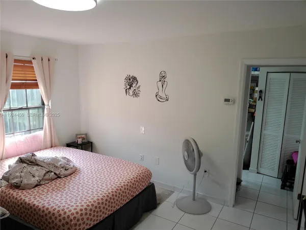 a bedroom with a bed and chandelier