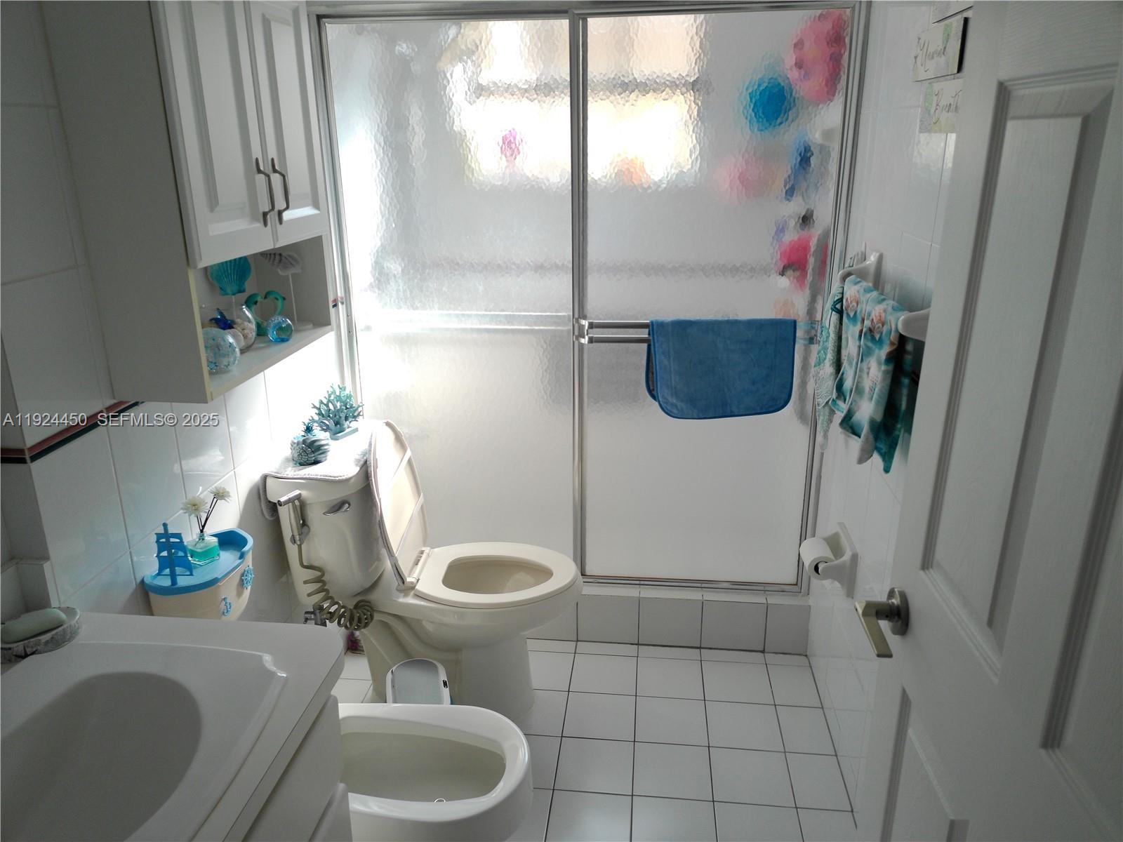 10812 Southwest 33rd Street Miami, FL 33165 - Photo 12 of 18 a bathroom with a sink toilet and shower