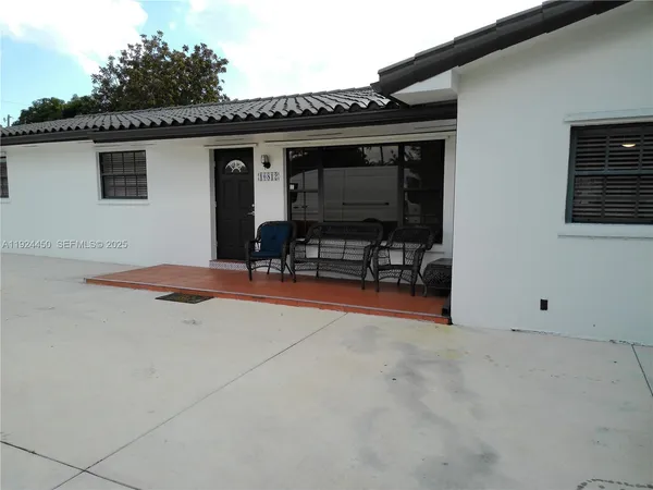 a backyard of a house with outdoor seating