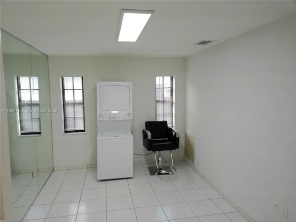 a view of a livingroom with workspace and a window