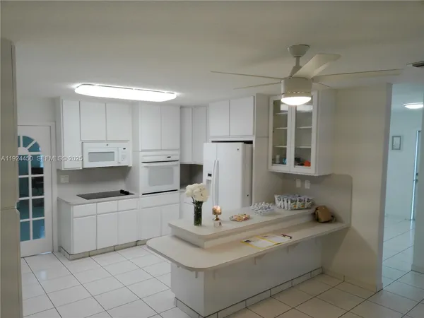 a kitchen with stainless steel appliances a sink stove and cabinets