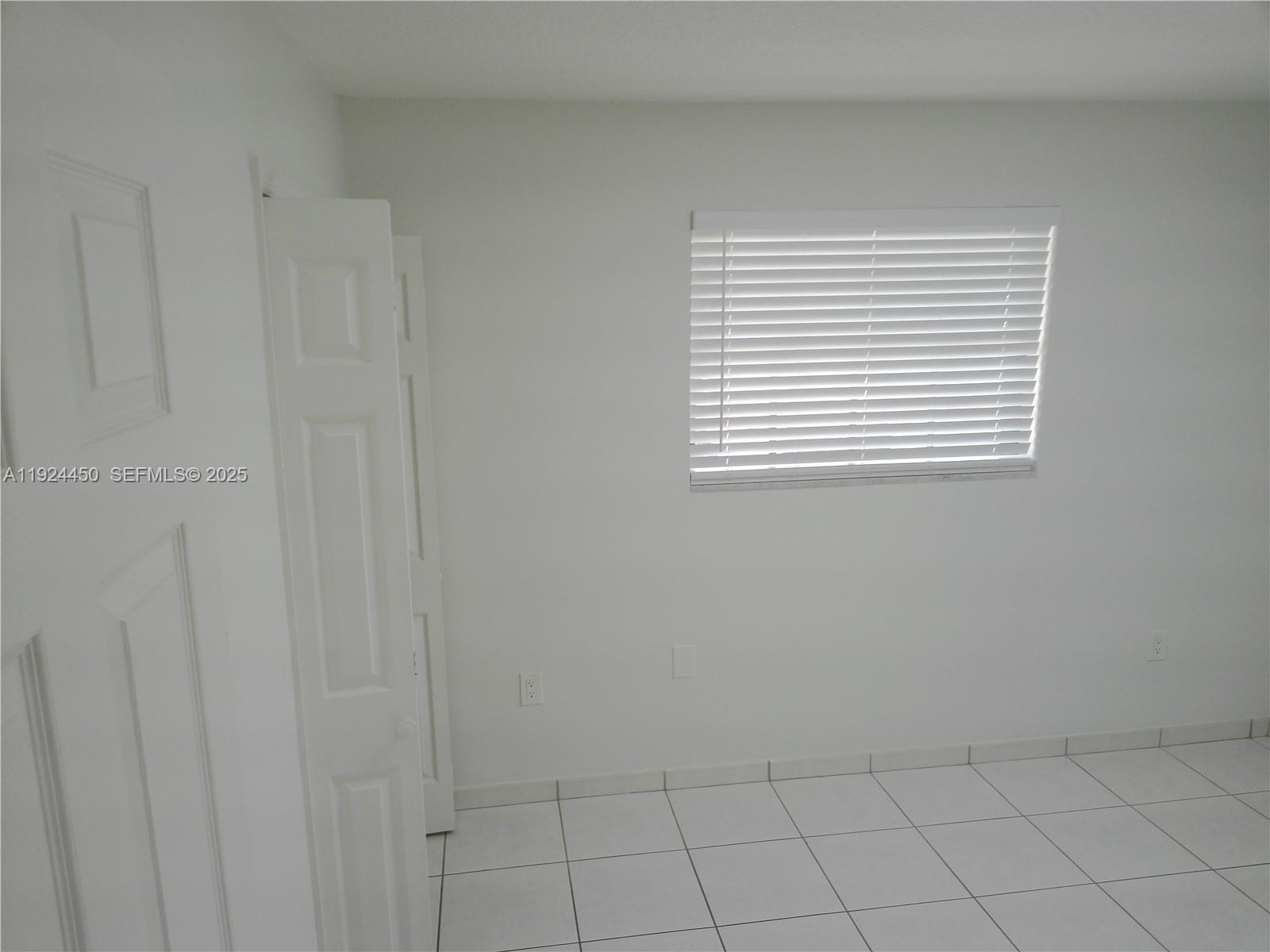 10812 Southwest 33rd Street Miami, FL 33165 - Photo 9 of 18 a view of an empty room with window