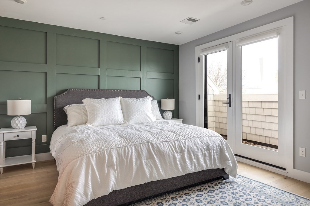 81-83 Alpine Street, Unit 2 Somerville, MA 02144 - Photo 12 of 24 a bedroom with a bed and wooden floor