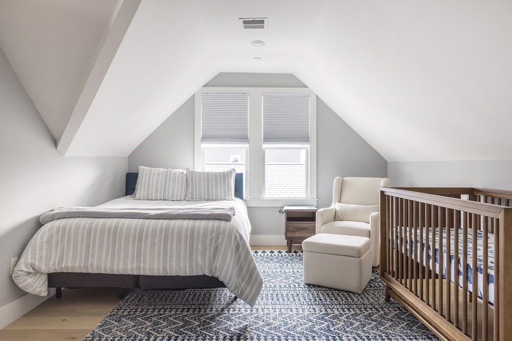 81-83 Alpine Street, Unit 2 Somerville, MA 02144 - Photo 16 of 24 a bedroom with a bed and a window