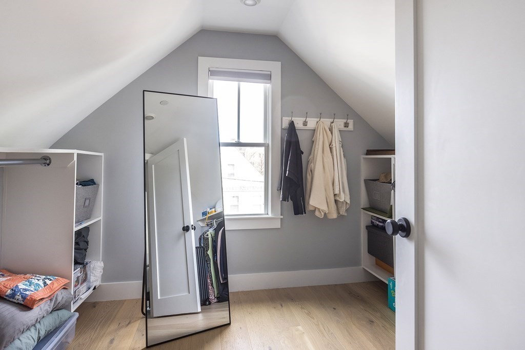 81-83 Alpine Street, Unit 2 Somerville, MA 02144 - Photo 18 of 24 a view of hallway with stairs and wooden floor