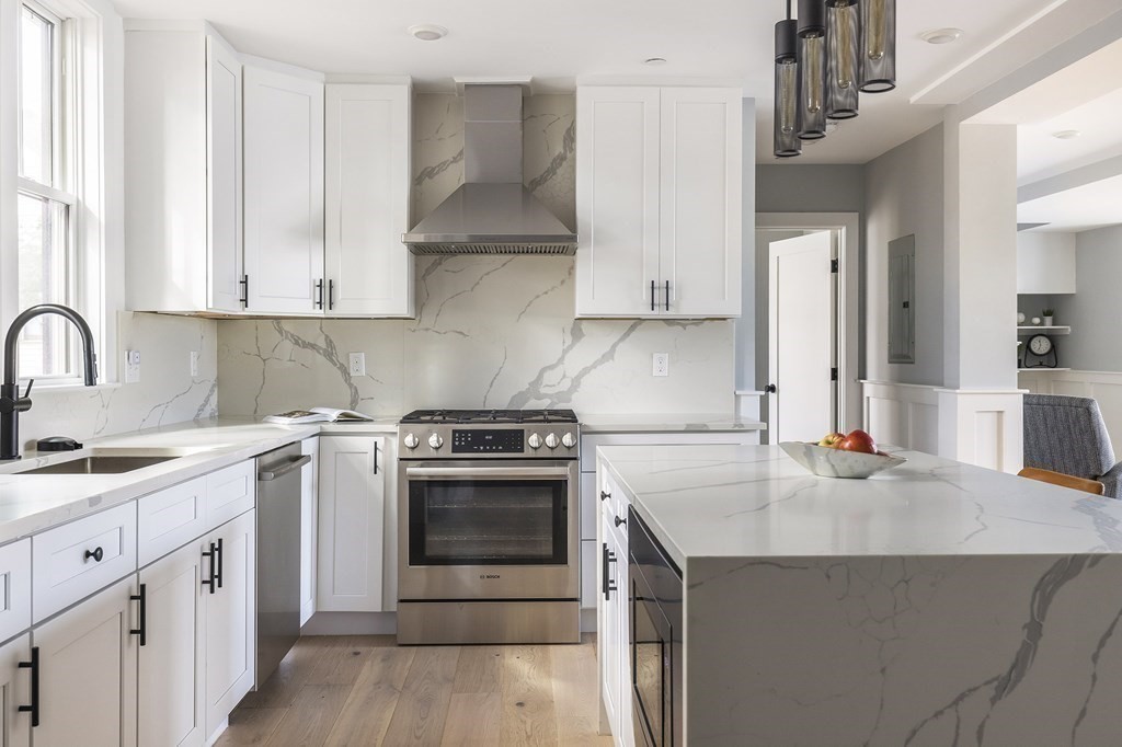 81-83 Alpine Street, Unit 2 Somerville, MA 02144 - Photo 2 of 24 a kitchen with stainless steel appliances granite countertop a sink stove and refrigerator
