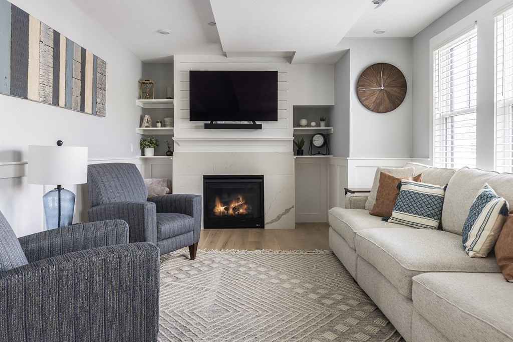 81-83 Alpine Street, Unit 2 Somerville, MA 02144 - Photo 5 of 24 a living room with furniture a fireplace and a flat screen tv