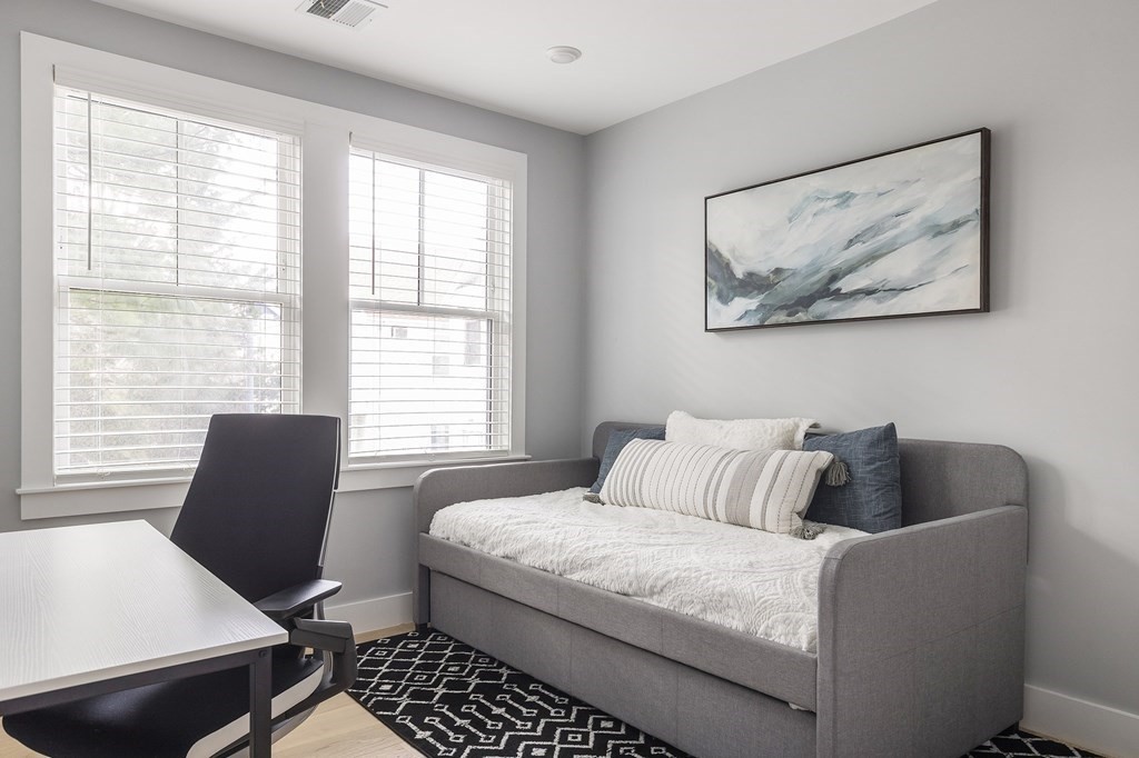 81-83 Alpine Street, Unit 2 Somerville, MA 02144 - Photo 8 of 24 a bedroom with a bed and a couch