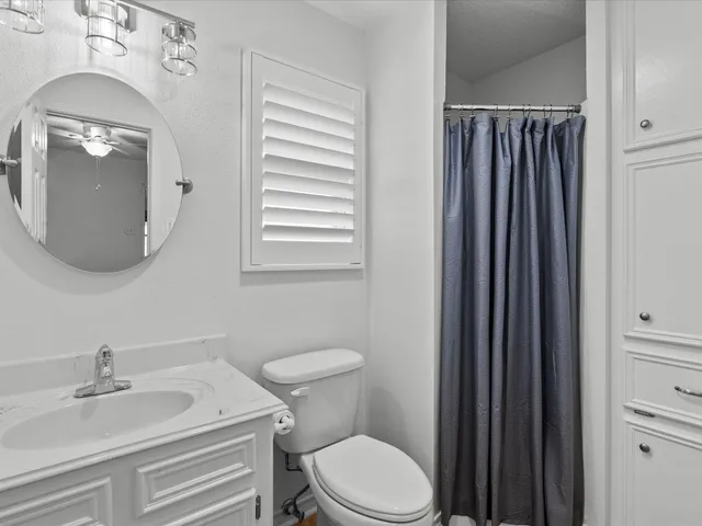 a bathroom with a sink a toilet and mirror